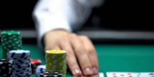 Blurred Croupier Laying Cards on Poker Table