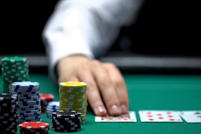Blurred Croupier Laying Cards on Poker Table
