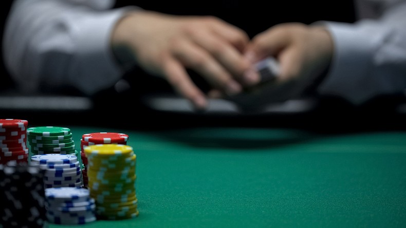 Casino Chips Against Blurred Hands of Card Dealer