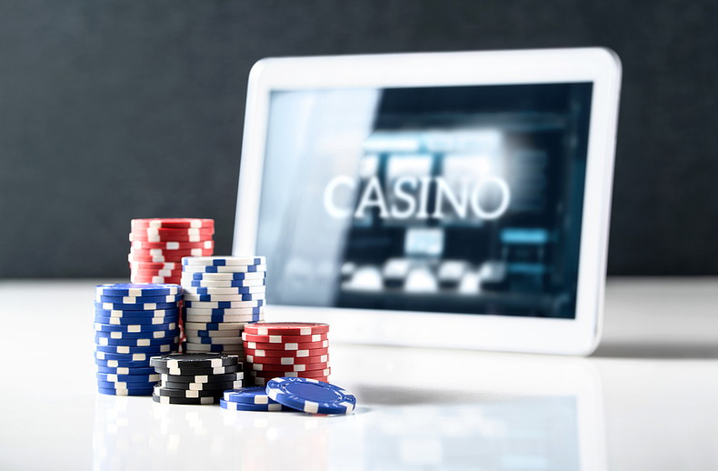 Casino Chips with Tablet in Background
