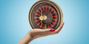 Female Hand Holding Small Roulette Wheel