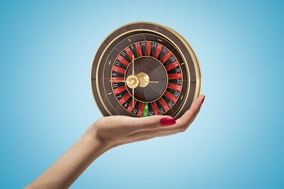 Female Hand Holding Small Roulette Wheel
