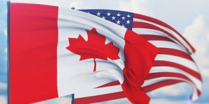 Flags of Canada and the USA Waving in Wind