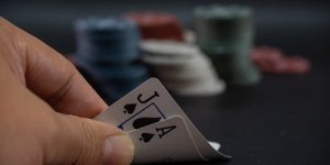 Gambler Looking at Blackjack Cards on Table