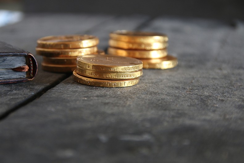 Gold Coins on Wooden Table