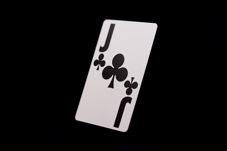 Jack of Clubs Against Black Background