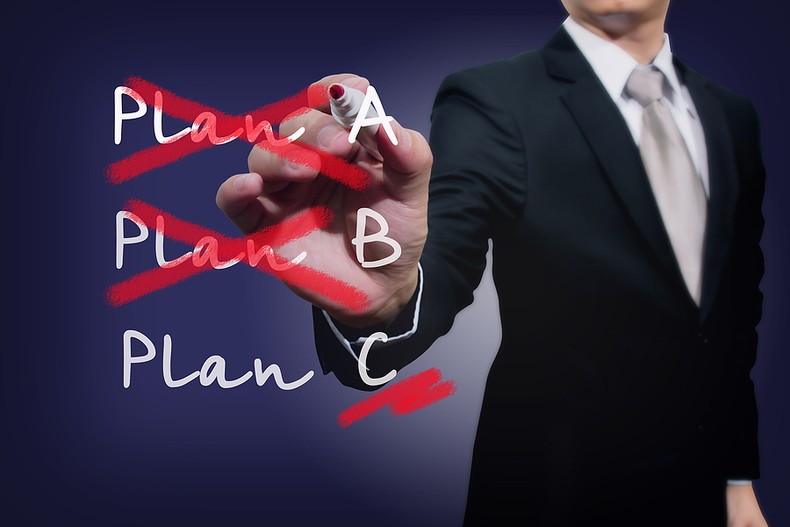 Man in Suit Highlighting Plan C