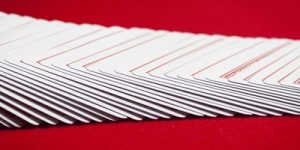 Playing Cards on Red Table