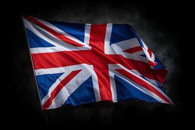 UK Flag Waving Against Dark Background
